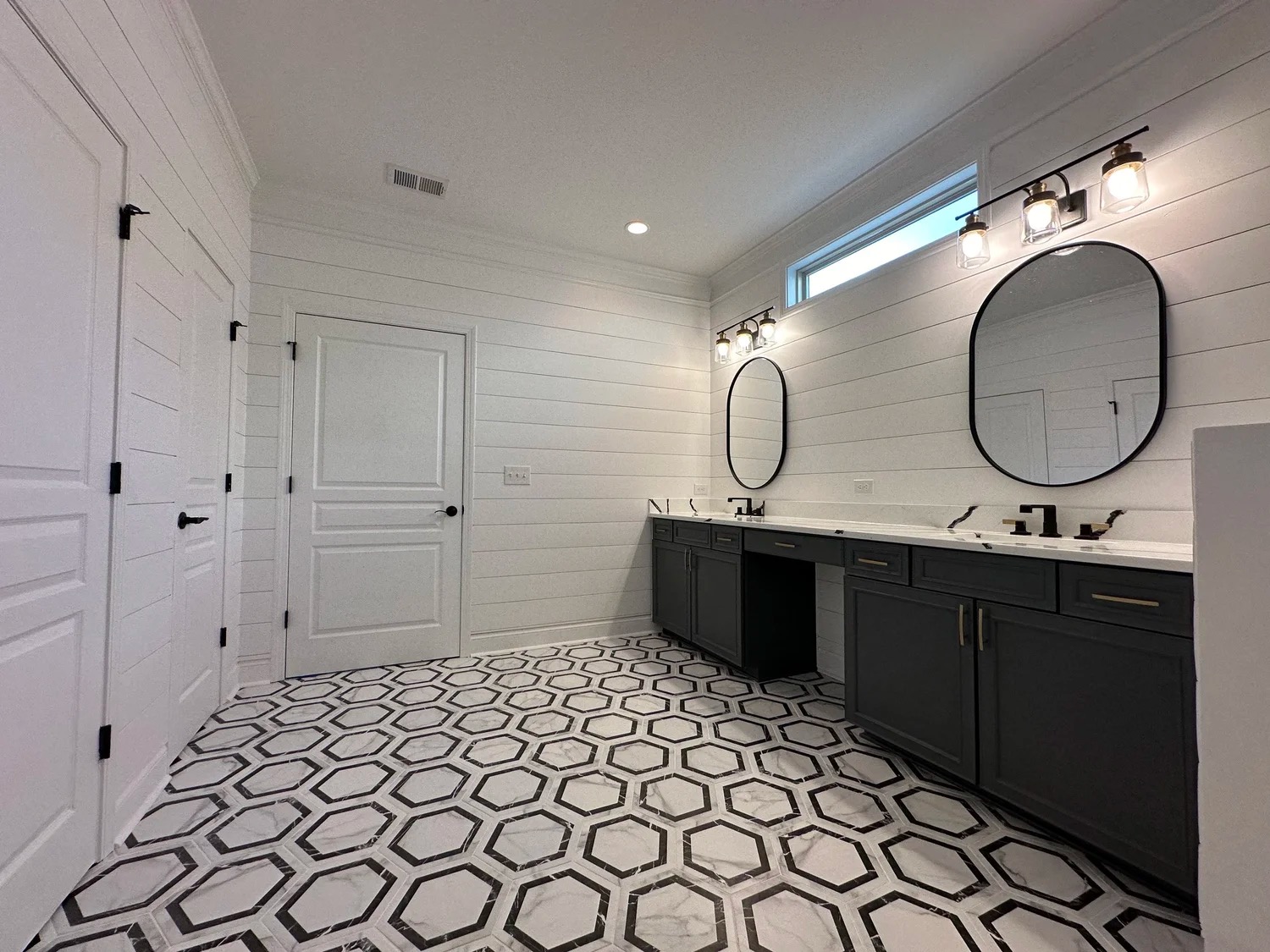 Full bathroom with dual vanity and hexagonal tile floor