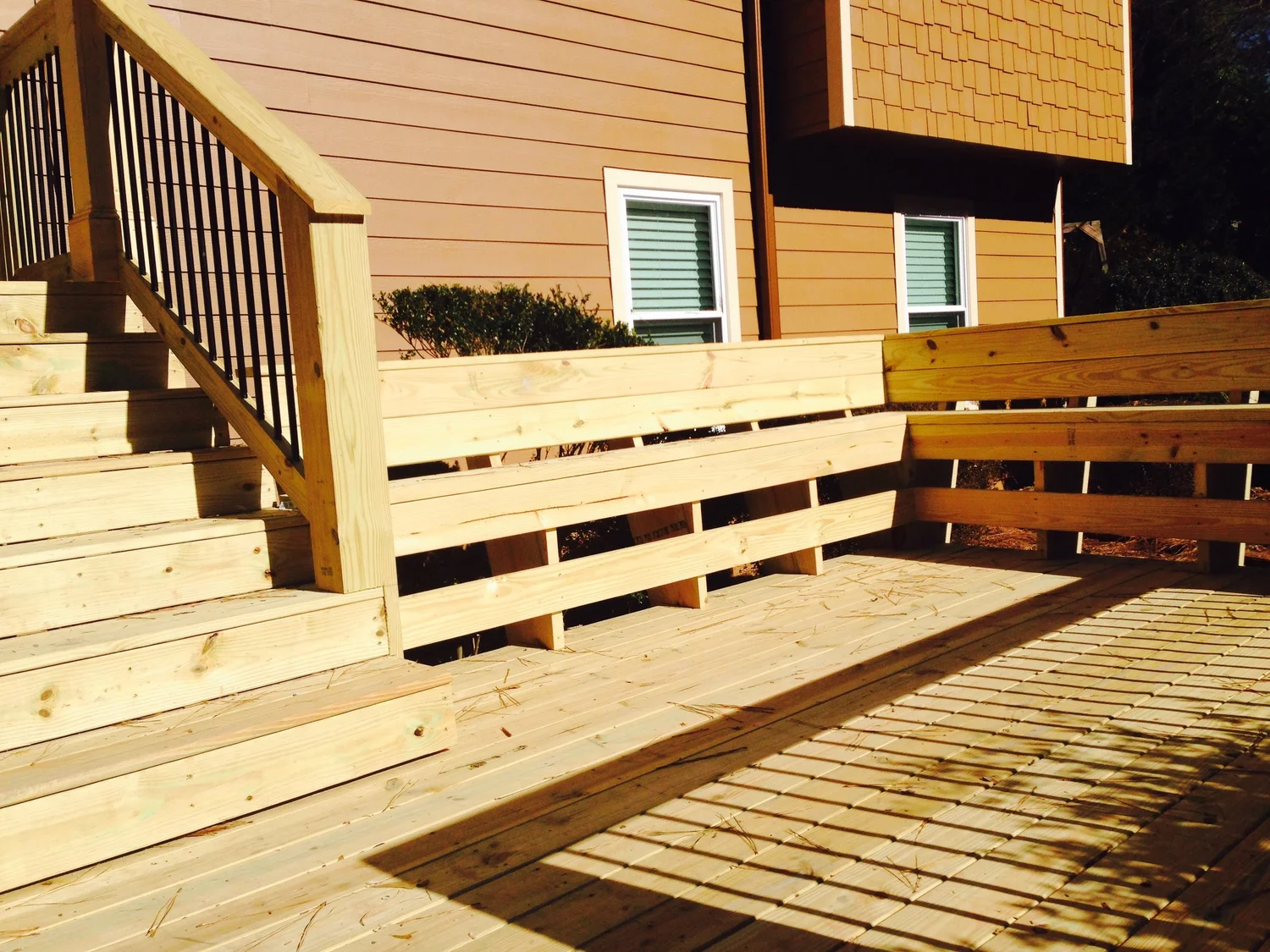 New pressure-treated deck with stairs and metal balusters