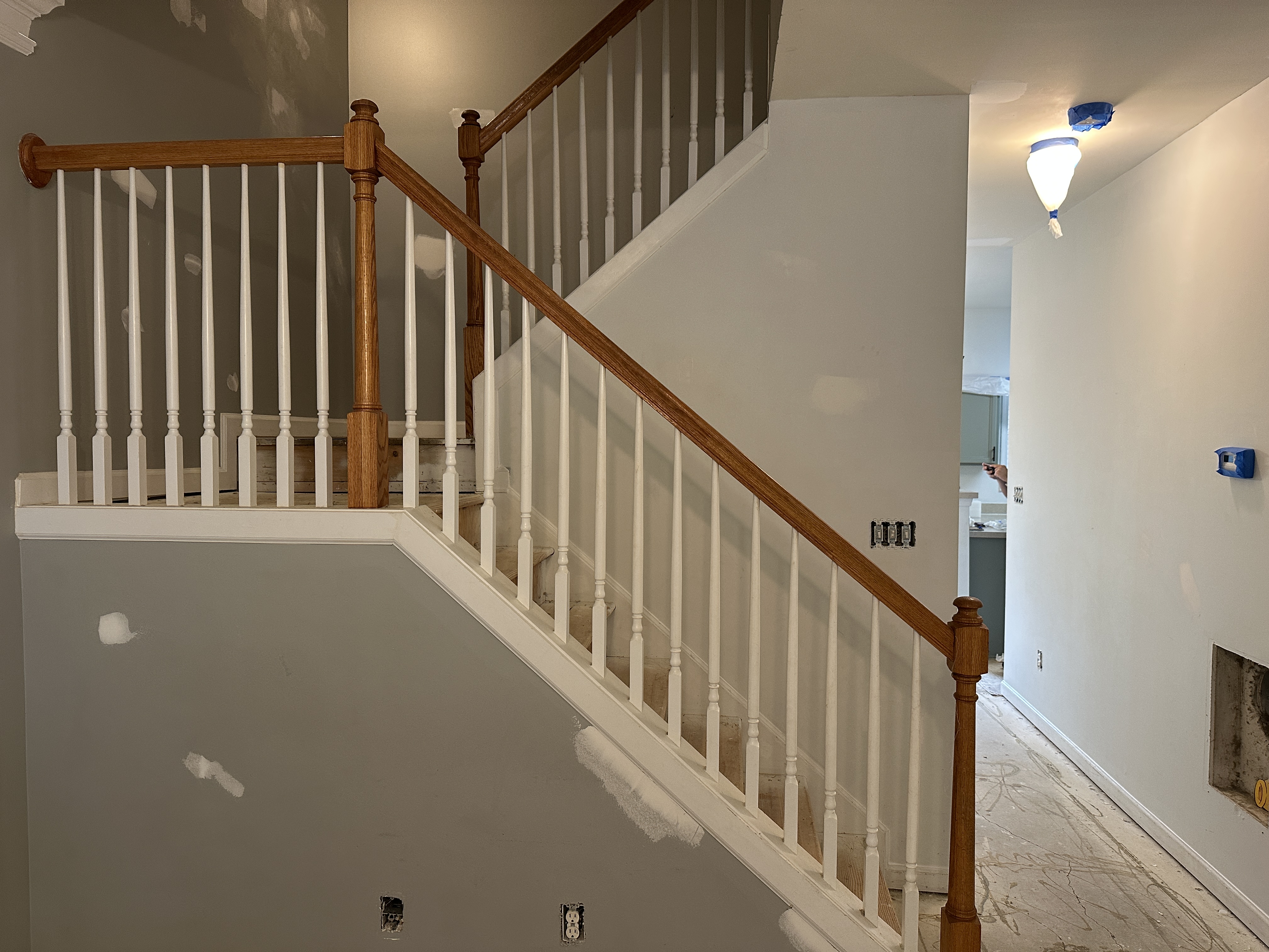 Staircase with oak handrail and white painted balusters